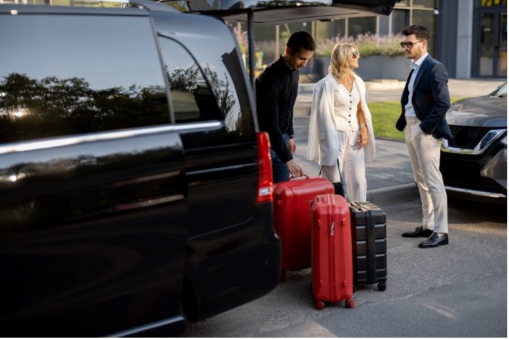 women packing bags from taxi car